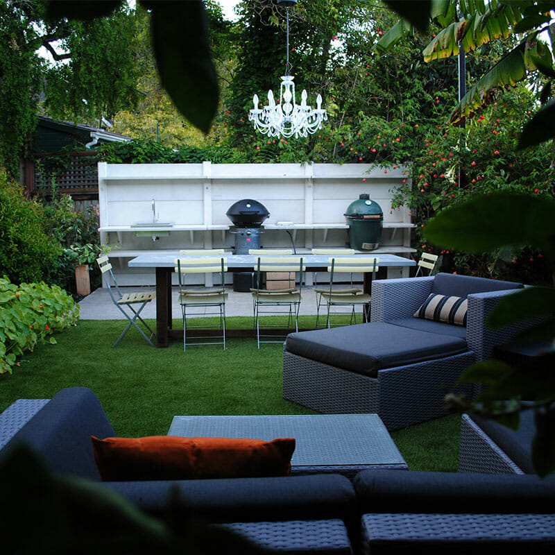 Backyard Oasis with Artificial Grass, Kitchen, and Lounge Fusion for Outdoor Bliss