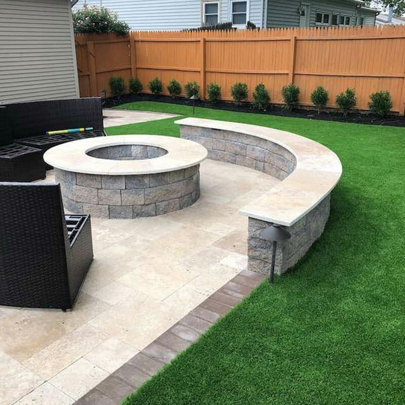 Integrating artificial turf into the landscaping around a patio and gas fire pit