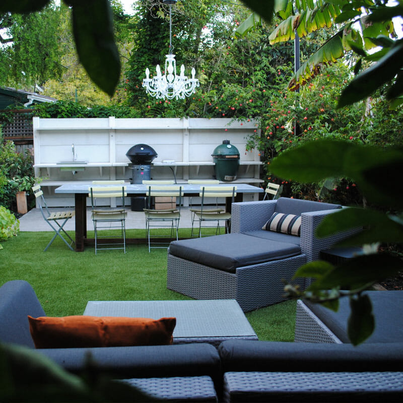 combining artificial grass with a kitchen and lounge area in your backyard