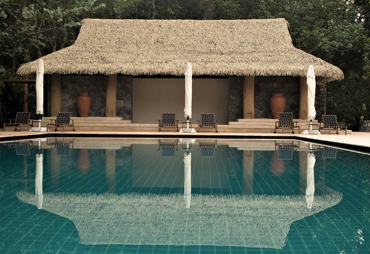 captivating fusion of artificial thatch and water features