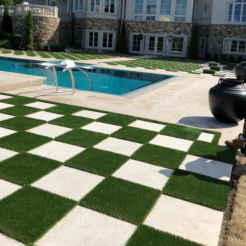 the checkerboard design with alternating squares of turf and pavers