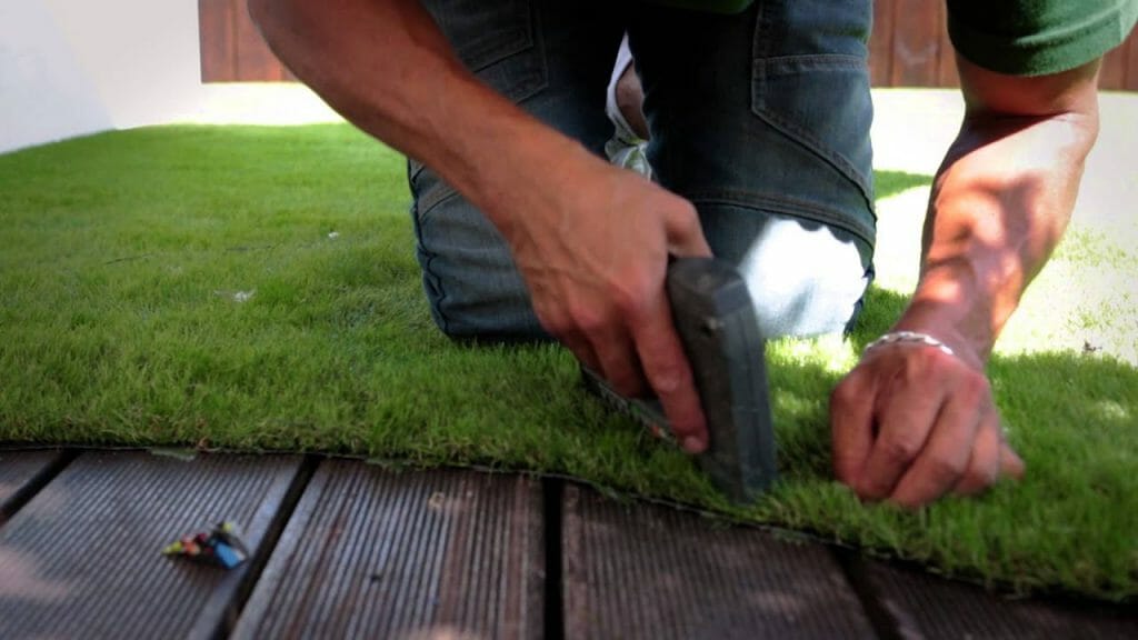 How to secure artificial grass to wood