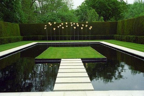 Water Feature in the Center of an Artificial Grass Lawn with Connecting Bridges
